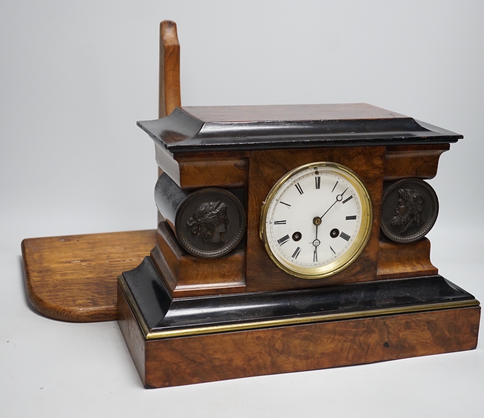 A Victorian walnut and ebonised bracket clock with two classical cartouches, 33cms wide x 23cms high not including bracket